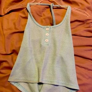 Light blue top. Open back and ties around the neck.